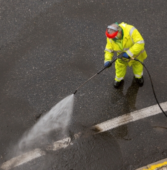 worker-cleaning-a-city-road-2022-03-16-22-30-20-utc